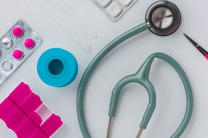 green and silver stethoscope on white envelope
