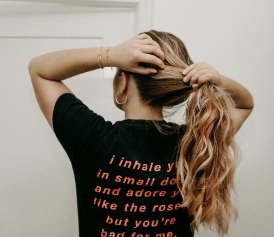 여름철 탈모 관리 방법 woman in black t-shirt covering face with hair