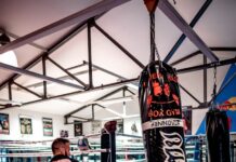 운동 부족으로 오는 질병들: 경고 신호와 대처법 woman in black and white shirt and black shorts standing on black and red boxing gloves