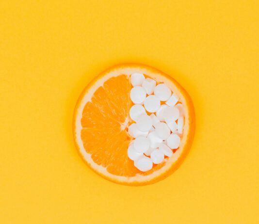 면역력 향상을 위한 비타민과 미네랄 섭취 orange fruit slices on yellow surface