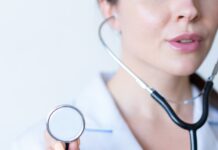 30~40대 여성을 위한 건강한 라이프스타일 팁 a woman in a white shirt holding a stethoscope